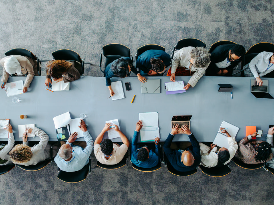 Employees collaborating around a conference table